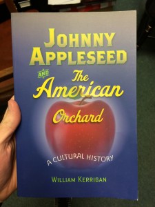 In the picture is a book of Johnny Appleseed, that Dr. Kerrigan has recently written. It is light blue, with a red apple in the center. 